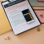 Organized business tools with a smartphone, documents, and stationery in a flat lay format.